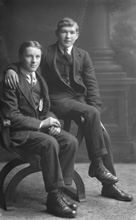 Two young men, both seated, possibly brothers.#    