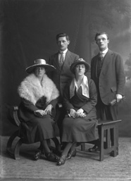 Two couples, portrait, men standing.#