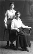 Mrs D. Fraser, The Steam Bakery, seated. The woman standing is found under image 23044 and named Mary Grant.