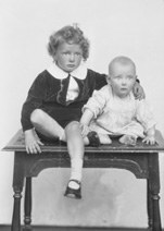 Grant, young boy and baby on table.