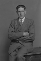 W. MacLean, with arms folded.