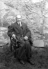 Mr Mackay. The book he is holding is 'Under the Dome of St. Paul's: A Story of Sir Christopher Wren's Days,' published in 1898. 