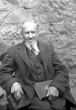 Mr Mackay. The book he is holding is 'Under the Dome of St. Paul's: A Story of Sir Christopher Wren's Days,' published in 1898.