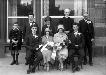 Morrison wedding group, with reflection of Inverness Castle in the windows of the Columba Hotel.