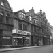 Timpson Shoes, located on the Inverness High Street. The building is no longer there, (the site is occupied by Shoe Zone), but the building on the left (Liptons Tea) is now the HSBC Bank. Image 26487a shows the Timpson store at the same location but with an earlier upper level facade. The elaborate building to the right is also gone, but the one on the extreme right of the photo still stands.*