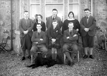 Miss MacDonald, Whitebridge. May 1928. The men have dark diamond shapes sewed onto their left sleeves.