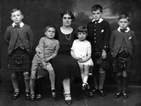 Jessie Macleod (nee Macrae) with Colin, Lorne, Duncan, Dodo and Ishbel. Jessie was a stage actress (see 26822b - the 1927 production of 'The Geisha'). Her husband was Colin Macleod. This family portrait was taken c1925. The boy Colin Macleod served during WWII in the Royal Navy. After being de-mobbed in 1946, he joined the merchant navy, where he rose to the rank of captain. During the early 1960s, he left the service and became Harbour Master at Inverness. He held this position for several years before re-joining the merchant navy. Lorne Macleod became a dentist and had his own practice in Huntly Street until he emigrated to Australia in 1967. Duncan Macleod also became a dentist with a practice in Boness and later Edinburgh. Donald 'Dodo' Macleod remained in Inverness and played football in his younger days for Inverness Thistle Football Club. Information kindly provided by Jessie's grandson Duncan Phillips.