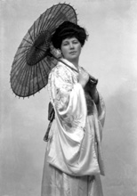 Carrie M. Cruickshank as Mimosa in the November 1927 production of 'The Geisha,' the story of a Japanese tea-house performed by the Northern Amateur Operatic Society. In the advert it was noted that prices would be increased for this attraction due to the lavish expense of the production (over ?200), in aid of the Queen Victoria Jubilee Institute for Nurses. A review noted that 'Miss Cruickshank has a beautiful voice, and went through the delicate Mimosa's ordeals of being sold and of selling with a sure finish.' #