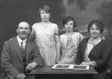 Family portrait around table.#