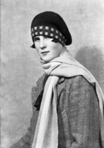 Woman with scarf and tartan bonnet.#