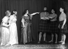 Theatrical actors dressed in costume. #