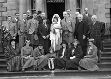 All family photo on steps at time of baby christening.#
