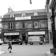 Friends' Provident Century Insurance, Macrae & Dick radio and tv shop and Mitchell & Craig (purveyors of fine foods and rare wines) in Academy Street, Inverness. Entrance to the Andrew Paterson Studio was to the left of Macre & Dick. *