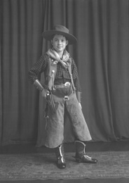 Andrew Chalmers dressed in a cowboy costume for a fancy dress party c1947. (see also refs: 33898, 39550 and 45474). He was a grandson of the famous photographer Andrew Paterson (1877-1948).