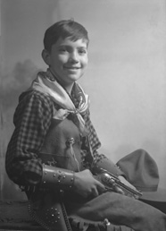 Andrew Chalmers dressed in a cowboy costume for a fancy dress party c1947. (see also refs: 33898, 39550 and 45474). He was a grandson of the famous photographer Andrew Paterson (1877-1948).