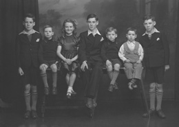 Stewart, Kessock Avenue, Inverness. Jimmy (far left) was twin brother to Sandy (far right). Willy (second left) was twin brother to Robert (third right). Mary and John. John was born a twin to Peter who died at 3 months. George Stewart (second right) is the only surviving sibling (2012). Unsure why the negative envelope has the address as Kessock Avenue. The Stewart family lived in Maclennan Crescent, Inverness.