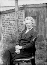 Older woman portrait, seated outdoors.# 