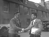 Captioned 'The Mod 1936, outside Cummings Hotel with Clarkie's Bar in the background.' Church Street, Inverness.* 