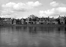 The River Ness and the Palace Cinema. The banner is promoting the movie 'Flight From Justice,' an American romantic drama released in 1938, directed by Nick Grinde. The film stars Robert Livingston, June Travis, John Gallaudet, Charles Halton and Ben Welden. For other images of the River Ness see H-0006, H-0009, H-0194, H-0195 and H-0196. For Palace Cinema interiors see 32034a/e. *