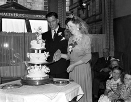 Inverness Wedding. Couple cutting the cake inside MacDougall's in Church Street. #