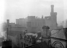 Mist over Inverness Castle with its old high outer walls, from across the rooftops of the now long gone buildings that once occupied the site of the present Tourist Bureau and Museum. Taken from the roof of the town house. Compare with image: H-0255. Courtesy John and Aithne Barron. * 