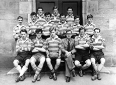 Rugby 1st XV 1948-1949. Rear: Ramsay Rae, Angus MacKenzie, Stanley D. Fleming. Middle: David Fletcher, John Sanderson, W.R Cameron, Martin Forrai, Ivan A. Fletcher, Lewis Nairn. Front: Harold C. Beaton (C), Allan E. Cameron, J. MacKenzie, Mr C.J Buchanan, Scott D. Moffat, Brian MacDonald. (Courtesy Inverness Royal Academy Archive IRAA_011).