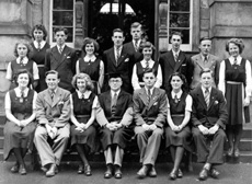 Inverness Royal Academy Prefects 1948-1949. Rear: Peggy MacLeod, Margaret MacLennan, Roderick A. MacLeod, Peggy Fraser, Stanley Fleming, James MacKenzie, Deirdre Munro, Frank Taylor, Ross Martin, Aileen Munro. Front: Erica Donald, Scott Moffatt (VC), Aileen Barr (C), Rector D.J MacDonald, Allan Cameron (C), Lorna Menzies (VC), Angus MacKenzie. (Courtesy Inverness Royal Academy Archive IRAA_045). See also 1878b-e. 