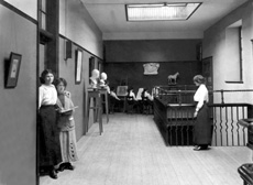 Inverness Royal Academy Corridor, Art Department, 1912. Between 1895-1980 the IRA was located in the Midmills building, currently the UHI-Inverness College (2013). The classroom scene was photographed at the time of the completion of the first extension to the Academy, running along Midmills Road opposite the side entrance to the Crown Church. The accommodation was shared in the early years with Inverness High School, when that school occupied the building which now houses the Crown School, only a short distance away. Accommodation included rooms for science and art, with a gymnasium and these are 'posed' publicity shots. (Courtesy Inverness Royal Academy Archive IRAA_054).