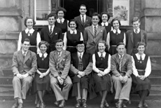 Inverness Royal Academy Prefects 1949-1950. Rear: Vaila MacLeod, John Sanderson, Sandra Oliver, Judy Kelly, Brian MacDonald, Will Cameron, Kathyrn Robertson, Aithne Rogers, Lewis Nairn. Front: Ramsay Rae, Peggy MacLeod (VC), Scott Moffatt (C), Rector D.J MacDonald, Aileen Munro (C), Ross Martin (VC), Deirdre Munro. (Courtesy Inverness Royal Academy Archive IRAA_060).