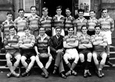 Rugby 1st XV 1949-1950. Rear: Ivan Fletcher, Garry MacNaughton, Ian Notman, John Williams, Alistair MacPherson, Morton Fraser, Donald W. Fraser, James Smith, Michael Maxwell. Front: John Sanderson, Lewis Nairn, Scott Moffatt (C), Mr C.J Buchanan, Brian MacDonald, Ramsay Rae, Will Cameron. (Courtesy Inverness Royal Academy Archive IRAA_061).