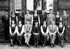 Inverness Royal Academy Prefects 1950-1951. Rear: Donald W. Fraser, Sylvia MacLeod, Gordon Beveridge, Derrick MacLennan, Annabel Brown, Duncan MacKenzie, Neil Smith, Esther Marr, Donald C. MacKenzie. Front: Jessmar Williamson, Sandra Oliver (VC), Will Cameron (C), Rector D.J MacDonald, Judy Kelly (C), Morton Fraser (VC), Kathryn Robertson. (Courtesy Inverness Royal Academy Archive IRAA_065).