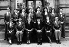 Inverness Royal Academy Prefects 1955-1956. Rear: Arthur Millwood, Alex MacNiven, John Robertson, Roderick MacKenzie. Middle: Ian Robin, Riona Marr, Ishbel Cameron, Carol Gordon, Iris More, Shonaid Robertson, Jean Stoker, John Miller. Front: Chrisalda MacKay, Robert Dewar, Miss E. Forbes, Rector D.J MacDonald, Mary Porteous, Ian MacPhee. (Courtesy Inverness Royal Academy Archive IRAA_098).