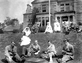 Recuperating soldiers and nurses relaxing on the front lawn of Hedgefield House Red Cross Hospital during the First World War. Fraser-Watts Collection)