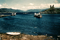 The ruins of Castle Moil (Dunakin Castle) occupies a headland above the village of Kyleakin facing the village of Kyle of Lochalsh across the strait. (Courtesy James S Nairn Colour Collection). ~ *