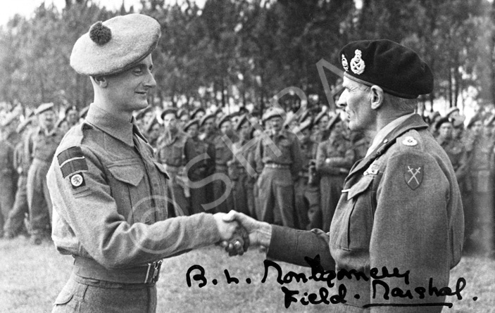 Copy of a photograph for Mrs MacPherson, 5 County Cottages, Trades Park, Nairn showing Field Marshal Bernard Law Montgomery shaking hands with a soldier of the Seaforths 15th Scots Division. The signature is Montgomery's own. See also image 083.  