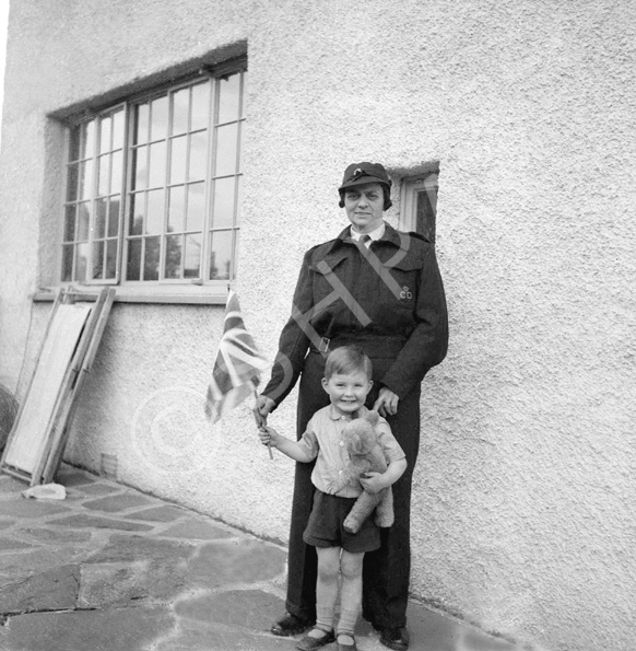 Stella Paterson wearing Civil Defense uniform with nephew Gilbert Paterson, at 7 Culduthel Gardens, Inverness c1945-1946. Her husband was Hector Paterson, son of famous photographer Andrew Paterson (1877-1948).