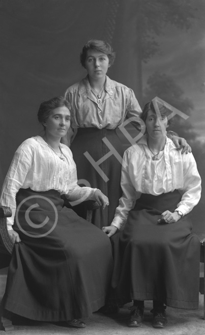 Three women, possibly sisters, posing in studio. Original plate broken on corner.#