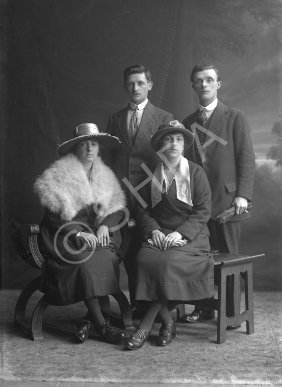 Two couples, portrait, men standing.#   