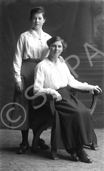 Mrs D. Fraser, The Steam Bakery, seated. The woman standing is found under image 23044 and named Mary Grant.