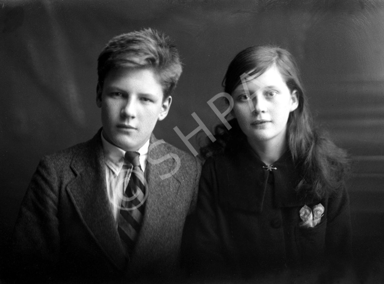 Miss Paterson, Kenneth Street, Inverness. The young man on the left is James Daniel Mackintosh (1905-1970), son of James Daniel Mackintosh (1867-1909) and Christina Christie (1877-1913). At right is his younger sister Maisie (1907-1920). After their parents died they were taken in at different times by several different relatives, including his mother's sister Anne, who had married Peter Paterson. James Daniel Mackintosh emigrated to the USA in 1923, after Maisie died in 1920. Peter Paterson was the brother of famous photographer Andrew Paterson (1877-1948), who also emigrated with wife Anne and daughter Dorothy in 1925. 