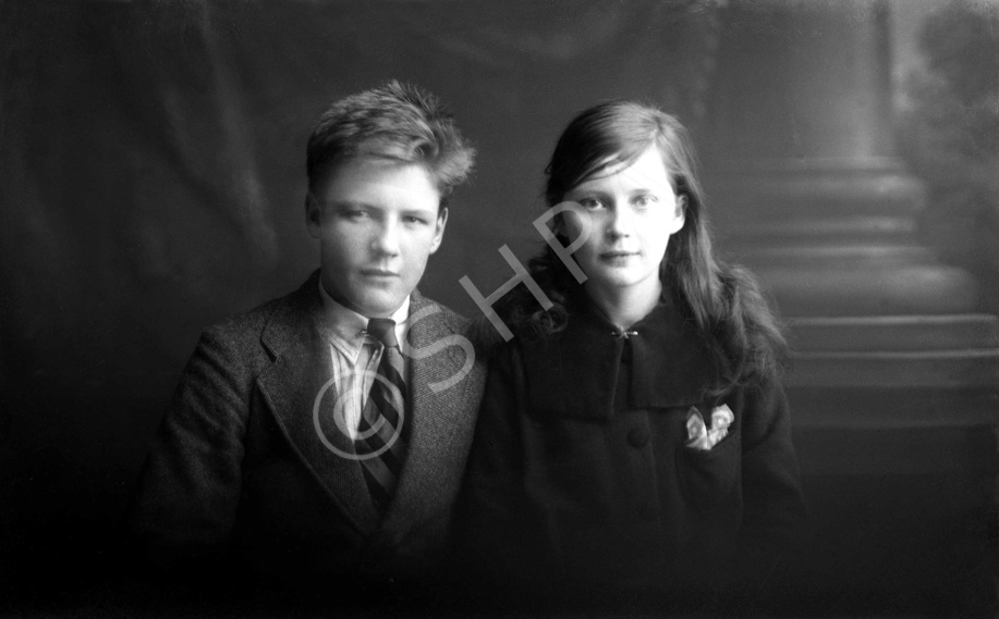 Miss Paterson, Kenneth Street, Inverness. The young man on the left is James Daniel Mackintosh (1905-1970), son of James Daniel Mackintosh (1867-1909) and Christina Christie (1877-1913). At right is his younger sister Maisie (1907-1920). After their parents died they were taken in at different times by several different relatives, including his mother's sister Anne, who had married Peter Paterson. James Daniel Mackintosh emigrated to the USA in 1923, after Maisie died in 1920. Peter Paterson was the brother of famous photographer Andrew Paterson (1877-1948), who also emigrated with wife Anne and daughter Dorothy in 1925.