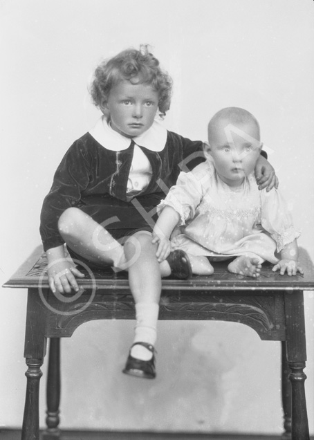 Grant, young boy and baby on table.