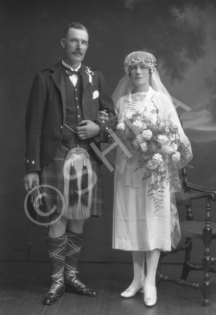 Bridal couple, groom in kilt.#