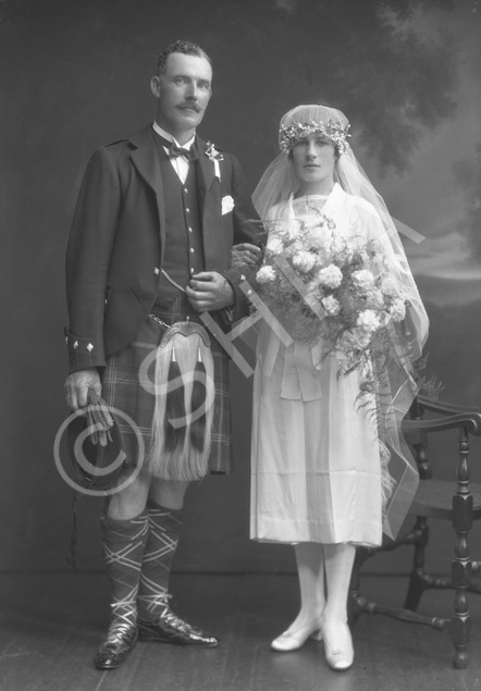 Bridal couple, groom in kilt.#