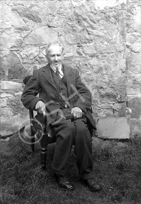 Mr Mackay. The book he is holding is 'Under the Dome of St. Paul's: A Story of Sir Christopher Wren's Days,' published in 1898. 