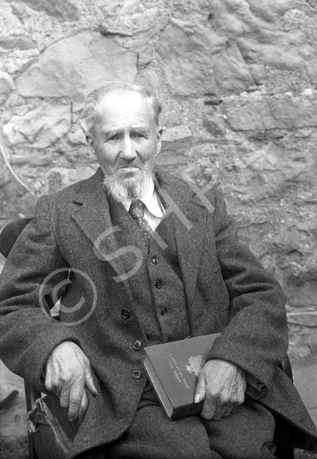 Mr Mackay. The book he is holding is 'Under the Dome of St. Paul's: A Story of Sir Christopher Wren's Days,' published in 1898.