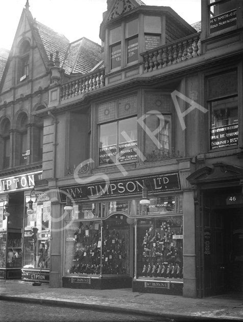 Timpson Shoes, located on the Inverness High Street. The building is no longer there, (the site is occupied by Shoe Zone), but the building on the left (Liptons Tea) is now the HSBC Bank. Image 26487b shows the Timpson store at the same location but with a renovated upper level facade.*
