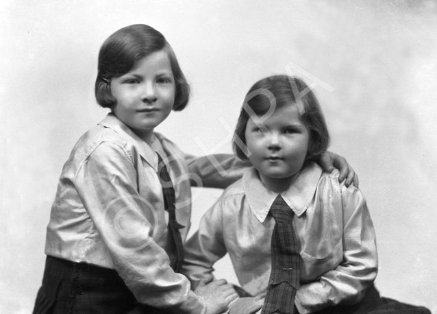 Two young girls, possibly sisters. #