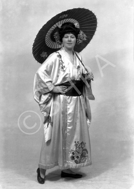 Carrie M. Cruickshank as Mimosa in the November 1927 production of 'The Geisha,' the story of a Japanese tea-house performed by the Northern Amateur Operatic Society. In the advert it was noted that prices would be increased for this attraction due to the lavish expense of the production (over ?200), in aid of the Queen Victoria Jubilee Institute for Nurses. A review noted that 'Miss Cruickshank has a beautiful voice, and went through the delicate Mimosa's ordeals of being sold and of selling with a sure finish.' #