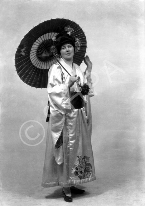 Carrie M. Cruickshank as Mimosa in the November 1927 production of 'The Geisha,' the story of a Japanese tea-house performed by the Northern Amateur Operatic Society. In the advert it was noted that prices would be increased for this attraction due to the lavish expense of the production (over ?200), in aid of the Queen Victoria Jubilee Institute for Nurses. A review noted that 'Miss Cruickshank has a beautiful voice, and went through the delicate Mimosa's ordeals of being sold and of selling with a sure finish.' #